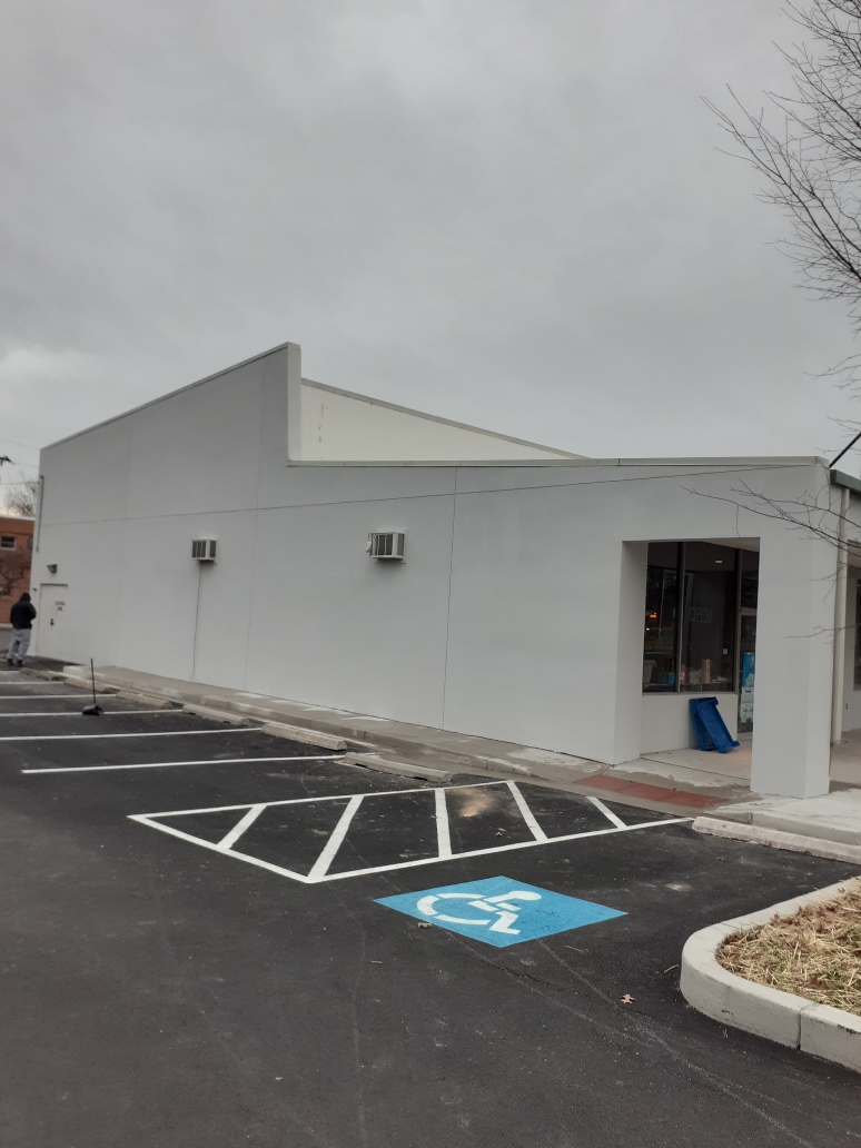 EIFS damage on a Hampton Roads building before repair